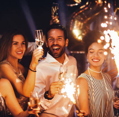 Shot of young friends holding sparklers at a party
